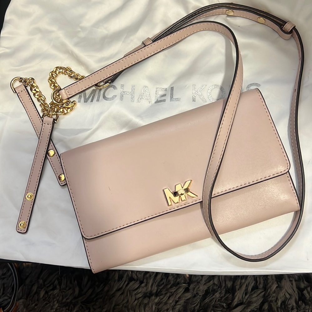 Light pink wallet or side bag .
